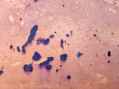 Dark ink pools on pink, violet blooms across the grain, abstract shadows rest