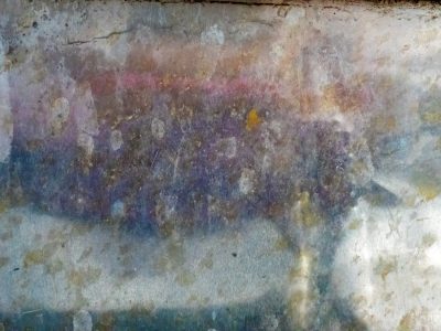 Green lichen meets the grey, ancient paths trace the surface, stone claims the light