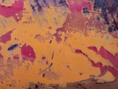 Layers peel away, orange fades to deep magenta, surface tells the tale