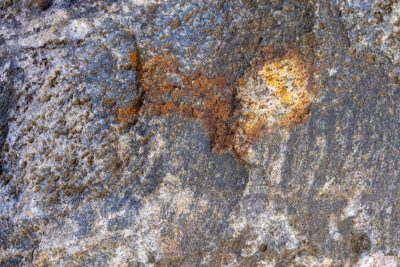 Grey fields meet the rust, orange spots claim the heavy, time marks the stone