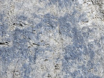 Grey patterns meet light, heavy grit claims the surface, years leave a deep trace