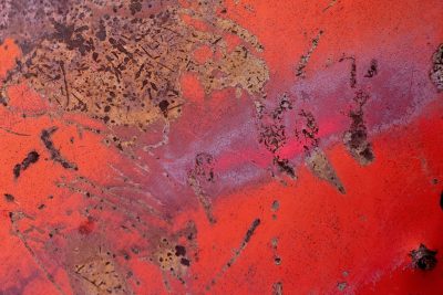 Grey pits mark the skin, jagged scars trace the heavy, time leaves a thick trace