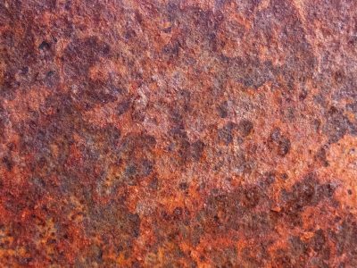 Iron turns to dust, orange scales of oxidation, metal breathes its last