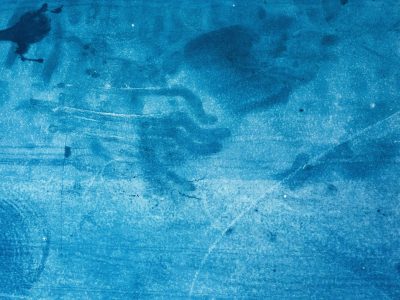 Jagged lines cut deep, dark stone holds the heavy mark, grit stays in the groove