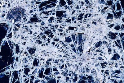 Jagged lines divide, clear shards hold the heavy light, fractured patterns stay