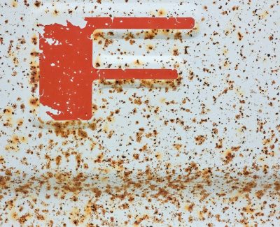 Maroon fields meet the sun, faded skin holds the surface, grit marks the finish