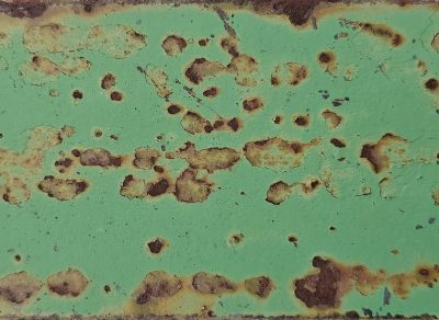 Mint paint wears away, orange rust spots bloom like clouds, metal meets the air