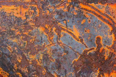 Orange fire on steel, iron turns to brittle dust, time eats through the frame