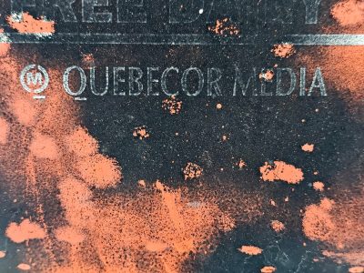 Orange splatters fall, Quebecor name starts to fade, time wears down the brand