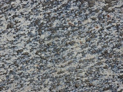 Pale grains flow through deep, pink mineral veins trace paths, light carves the surface