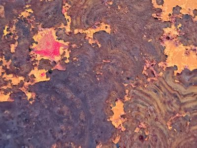 Peeling orange paint, swirling rust eats through metal, colors fade to brown
