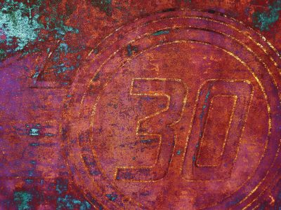 Thirty etched in steel, teal and orange start to bleed, metal marks the time