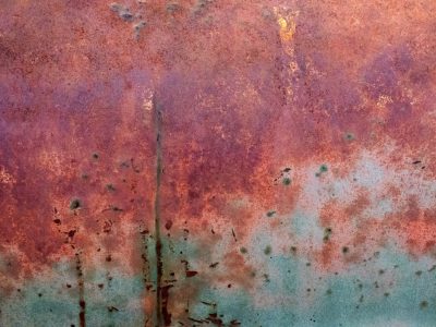 Purple mist fades low, teal fields meet the edge, grit marks the changing