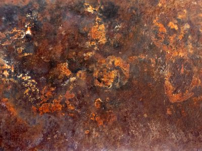 Orange flakes of iron, shadows bloom across the steel, time eats through the skin