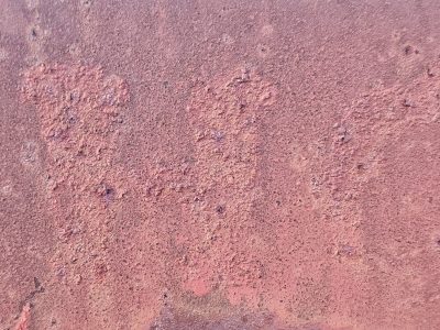 Red dust coats the iron, rough scales form on metal skin, age eats through the core