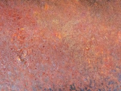 Red dust coats the steel, oxidation blooms in heat, time eats the metal