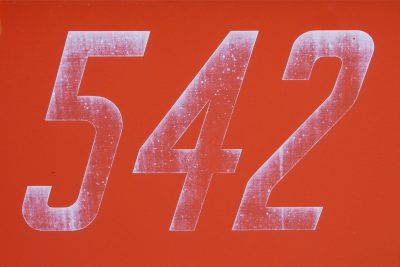 Red fields hold the light, white numbers mark the surface, grit traces the edge