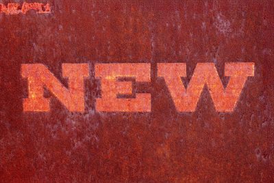 Red fields meet the rust, "NEW" script marks the heavy skin, time marks the metal