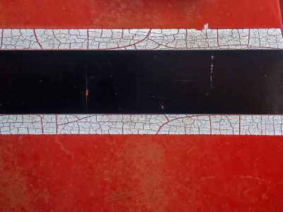 Red fields meet the sun, faded skin holds the surface, grit marks the finish