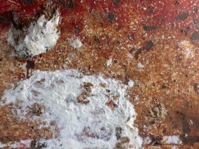 Red skin has white trails, jagged paths trace the heavy, light carves the metal