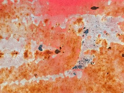 Red skin turns to grit, mottled paths trace the heavy metal, light carves the surface