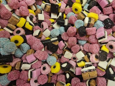 Red stripes meet the white, sugary paths trace the surface, light marks the candy