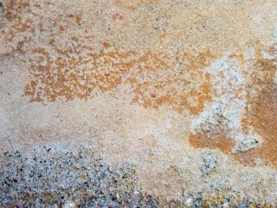Sandy textures mix, rusty stains across the slab, gritty base remains