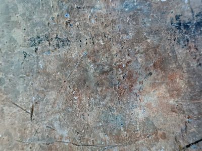 Scratches mar the steel, brown rust blooms on cold blue grey, time wears down the skin