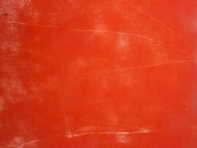 Searing orange field, white scuffs mar the vibrant glow, time leaves its light mark