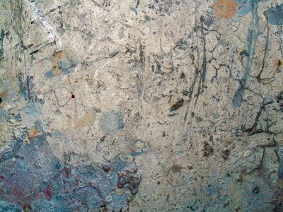 Silver metal scars, traces of blue paint remain, time wears down the shine