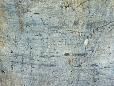 Silver skin turns to grit, jagged paths trace the field, light carves the metal