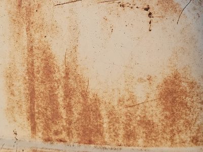 Stenciled lines meet the grit, heavy paths trace the surface, time marks the metal