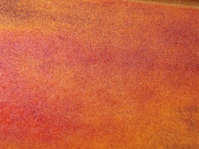 Stippled orange field, metal yields to oxidation, time eats at the steel