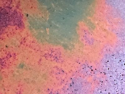 Teal sea meets the rust, colors bleed across the steel, time claims every inch