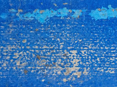 Vibrant blue decays, pale stone breaks the surface, textures tell the tale