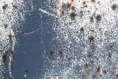 White paths meet the blue, heavy pits mark the surface, grit marks the finish