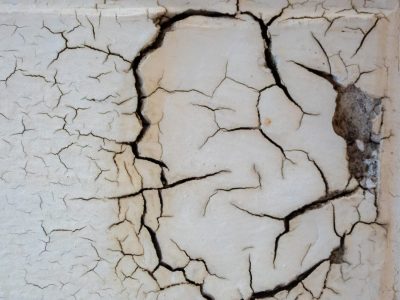 White shell starts to split, dark veins crawl across the wall, surface turns to dust