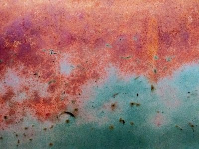 Yellow fields meet black, heavy grit claims the concrete, safety wears to stone