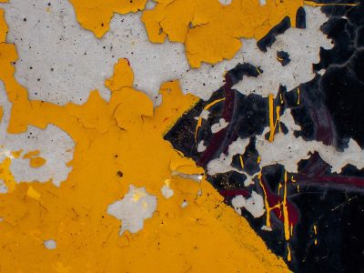 Yellow fields meet grey, jagged paint flakes off the skin, grit holds the center