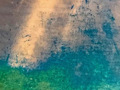 Amber meets the blue, scratches mark the metal skin, oxidation blooms