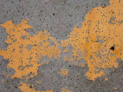 Yellow skin holds grit, jagged edges meet the light, time wears the finish