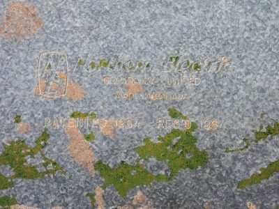 Cold galvanized steel, moss and rust creep o'er the words, sixty four remains