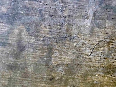 Zinc patterns emerge, scratches mark the cold surface, silver turns to dust