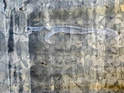 Zinc spangles shimmer, ghostly white streaks across steel, weathered metal skin