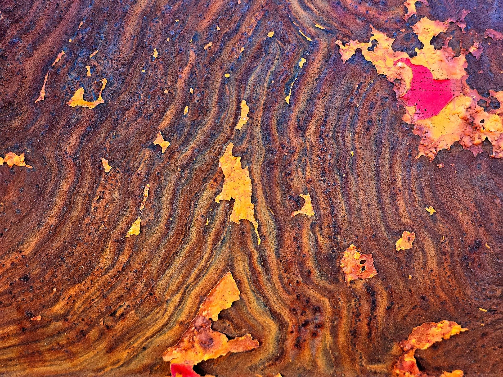 Wavy lines of rust, orange grit claims the surface, time leaves a deep mark