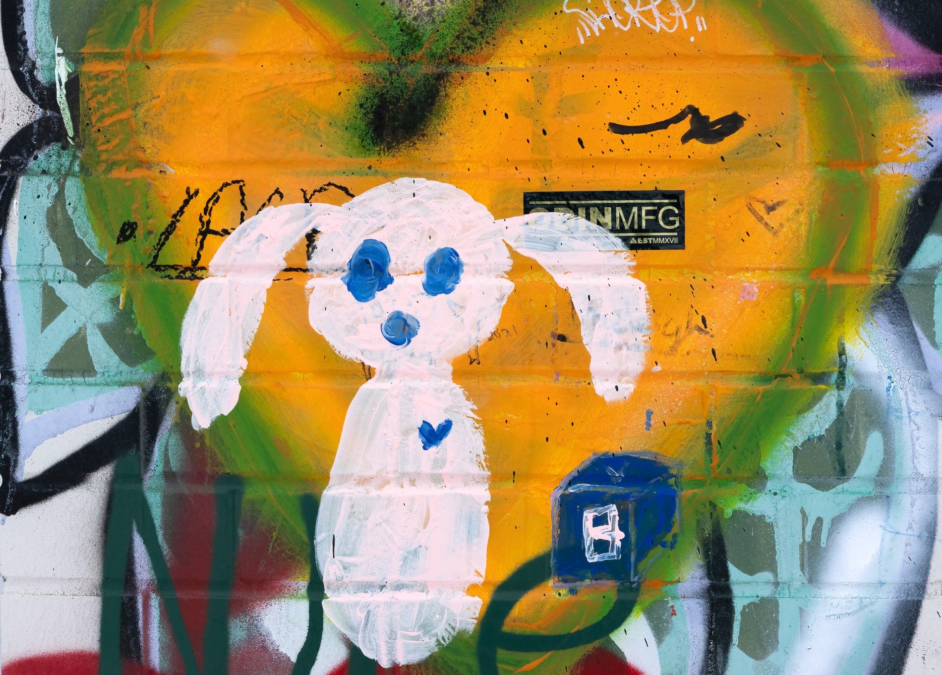 White ghost haunts the wall, yellow heart glows in the paint, blue eyes watch the street