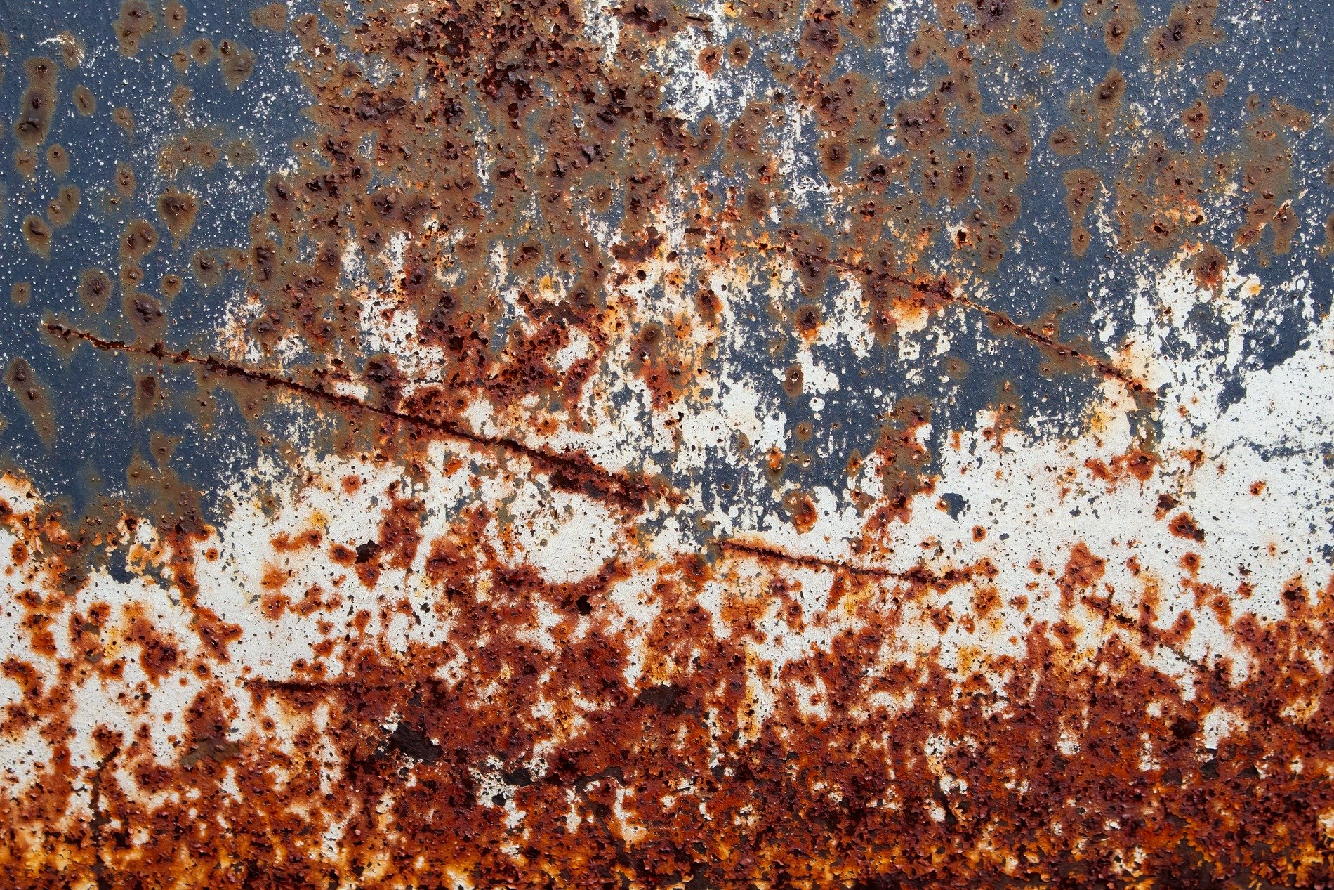 White skin flakes away, blue fields meet the heavy pits, grit marks the finish