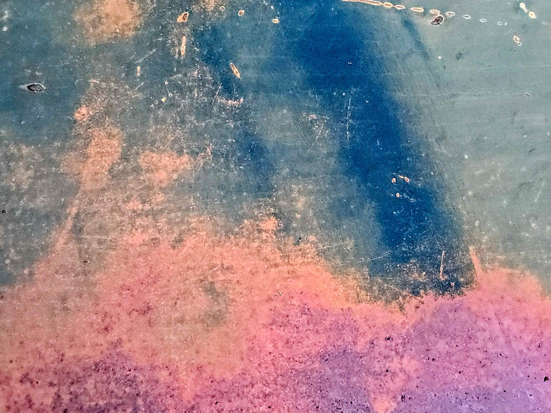 White skin has red trails, vertical streaks trace the field, grit marks the finish