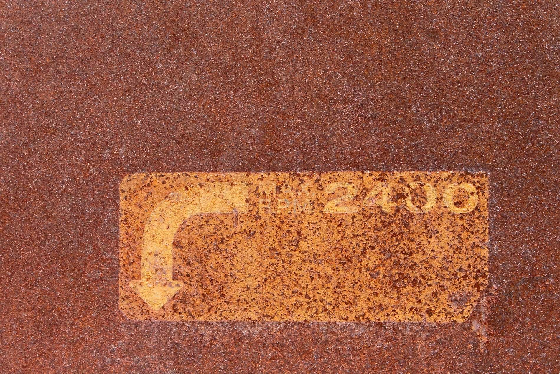 Red rust eats the steel, yellow arrow points the way, speed fades in the dust