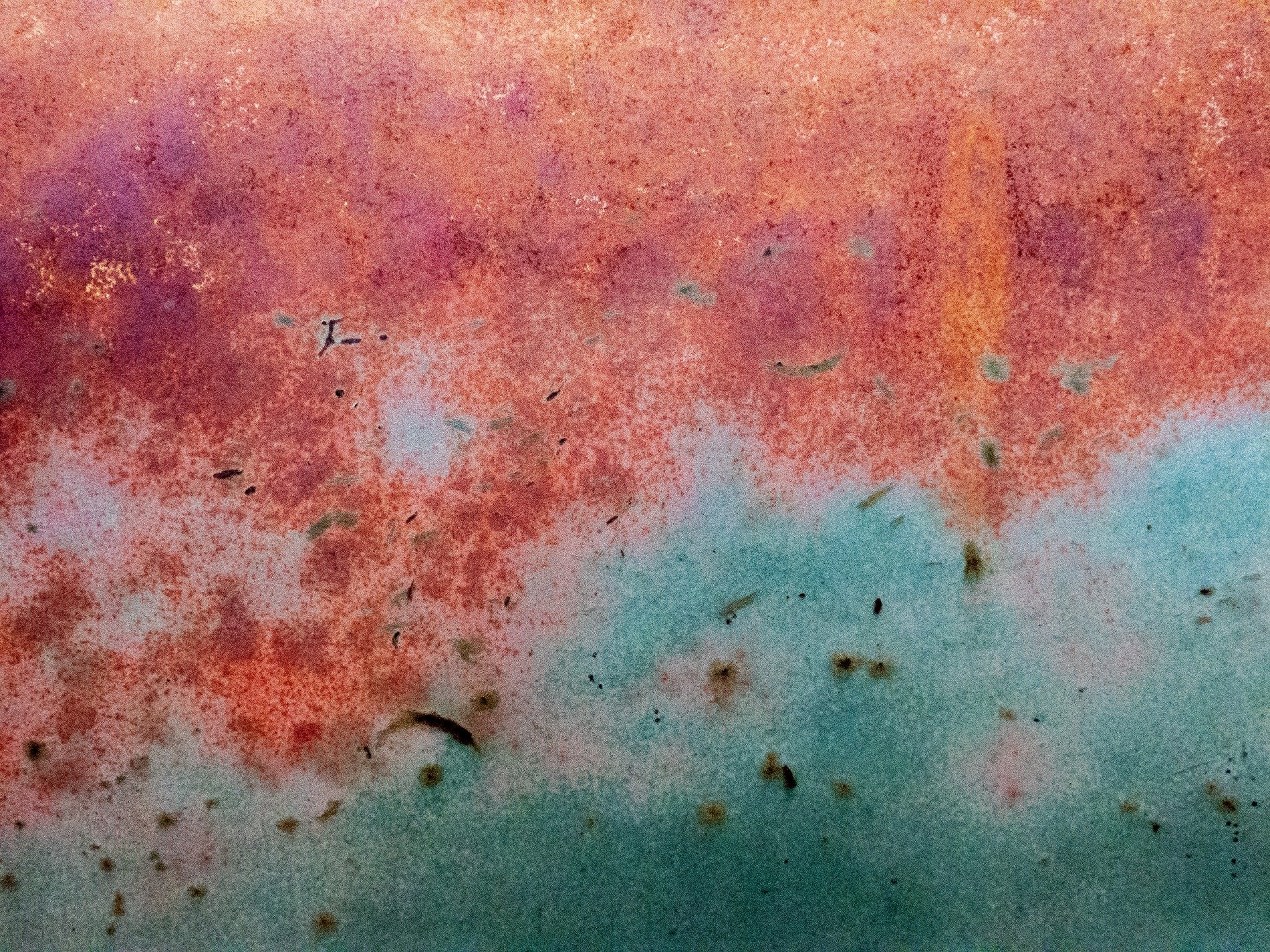 Yellow fields meet black, heavy grit claims the concrete, safety wears to stone